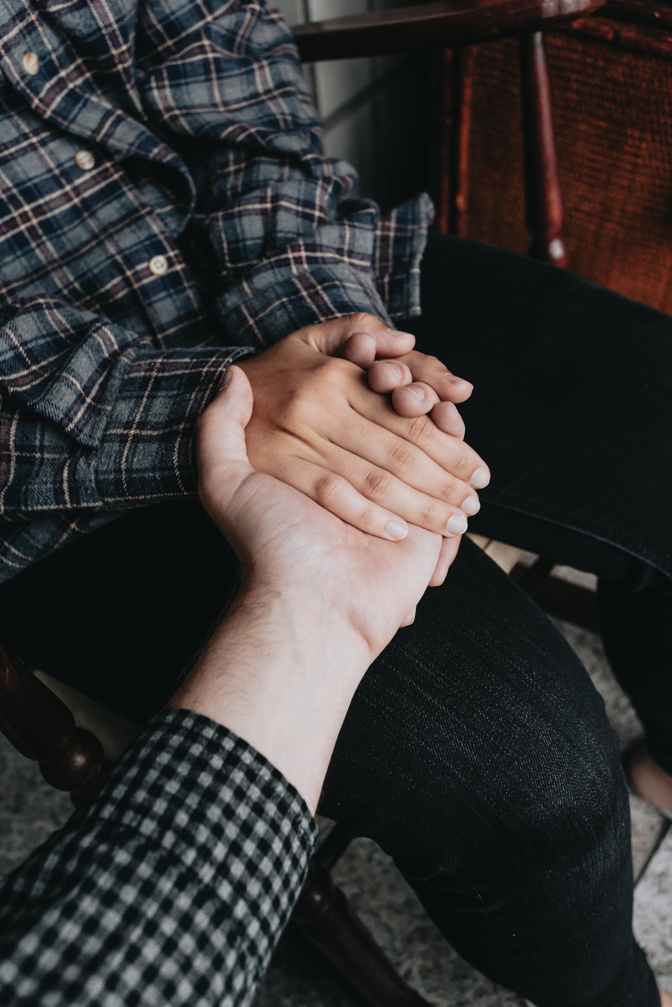 two-people-holding-hands-while-sitting-down.jpg